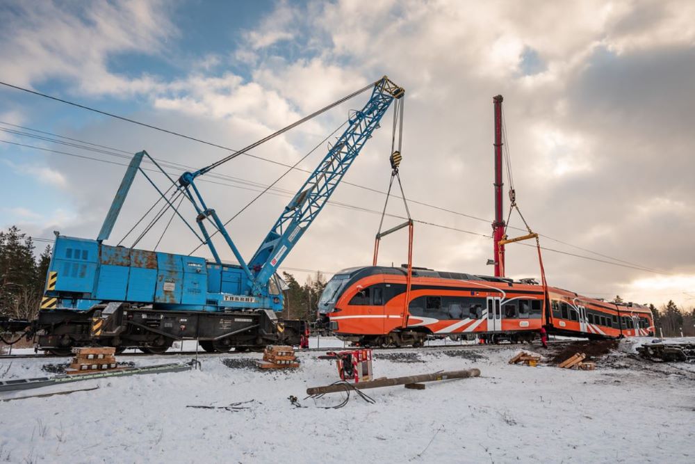 Multiple cranes trying to remove a derailed train from the track